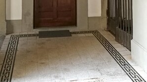 A hallway with a wooden door and a metal gate. - Mezzo 46 in Firenze With 2 Bedrooms and 2 Bathrooms (Florence)