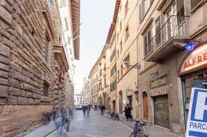 A narrow street with historic buildings, a visible shop named 'Bottaccini', and a sign for 'Alfredo'.