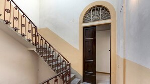 A staircase with ornate metal railings leading to a door with a window above. - Benedetta 8 in Firenze (Florence)