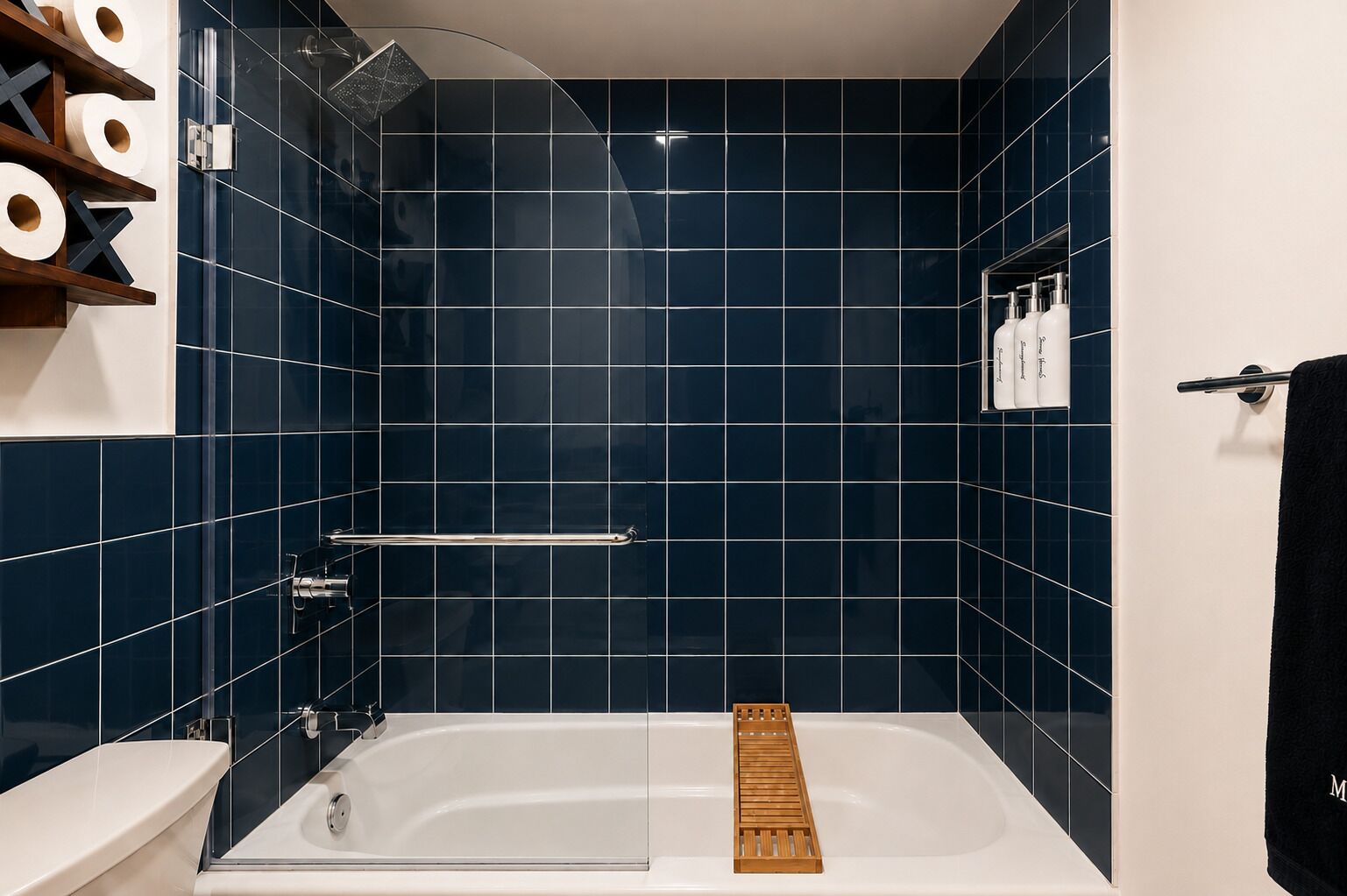 A modern bathroom with a bathtub, shower, and toilet.