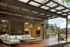A modern living room with a sofa, TV, and wooden coffee table.