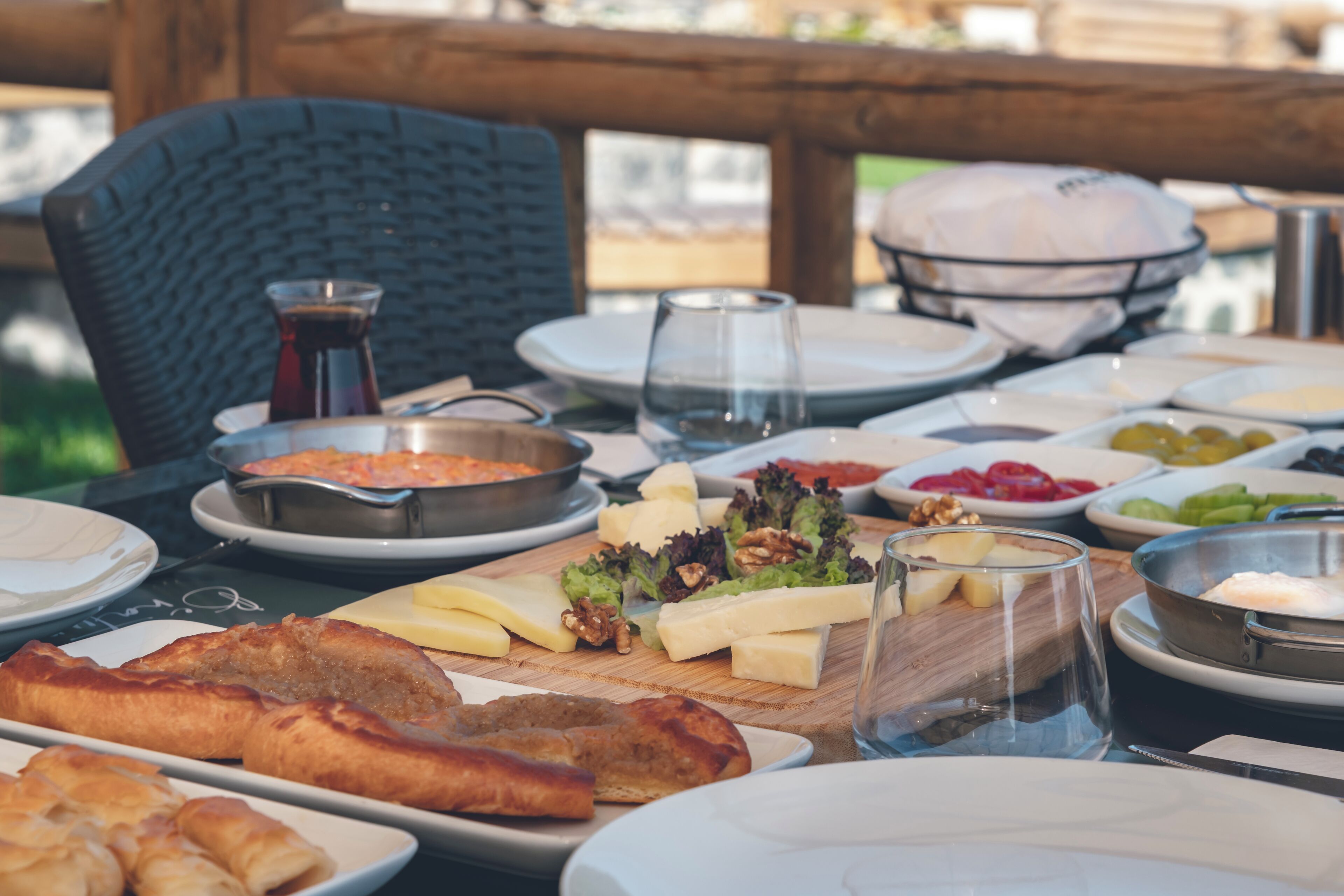 A table set with various food items including cheese, nuts, and bread, suggesting a buffet or communal meal setting.