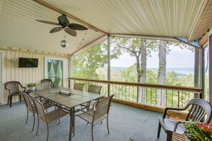 A covered patio with a table and chairs, a ceiling fan, and a view of trees and mountains. - Bright Byrdstown Home w/ Views of Dale Hollow Lake (Byrdstown)