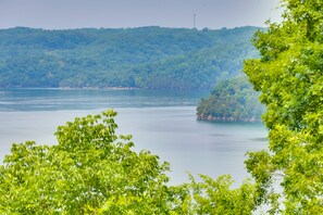 A view of a lake with a forested hill in the background. - Bright Byrdstown Home w/ Views of Dale Hollow Lake (Byrdstown)