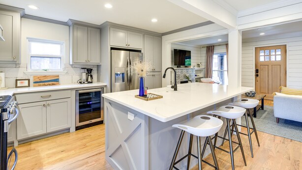 A modern kitchen with a large island, stainless steel appliances, and bar stools. - ‘Pecan Blue’ Frisco Hub: Dtwn, Dining & Stadiums! (Frisco)