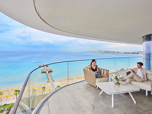 A modern balcony with a clear view of the sea and a distant shoreline. - Swissôtel Resort And Spa Cesme (Cesme)