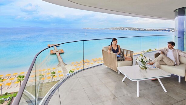 A modern balcony with a clear view of the sea and a distant shoreline. - Swissôtel Resort And Spa Cesme (Cesme)