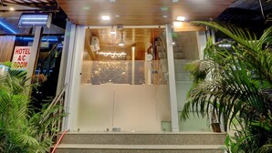 The exterior of Hotel Amber Suite with a sign indicating it is an A/C room. - Hotel Amber Suite (Mumbai)