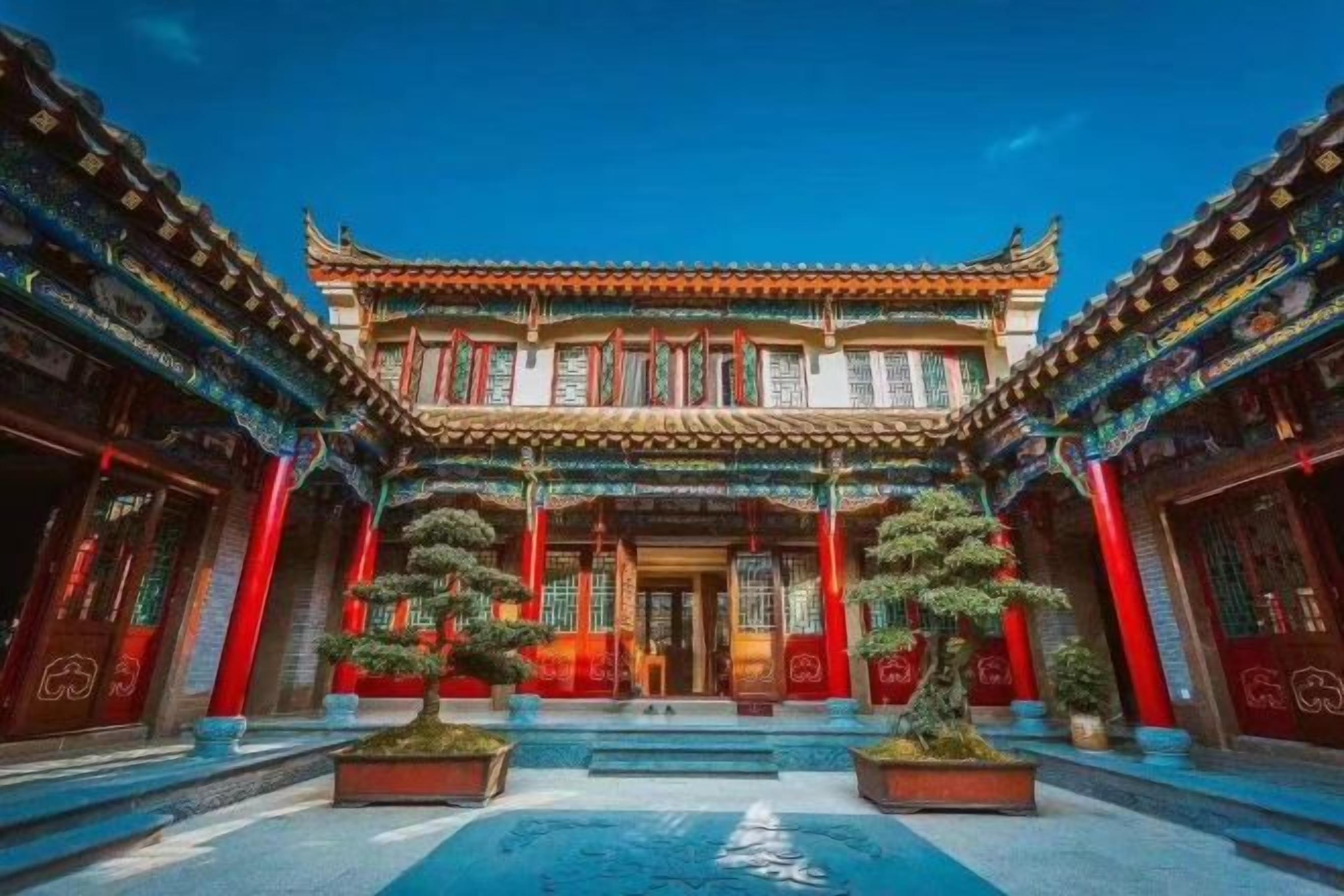 A traditional building with a symmetrical facade, multiple windows, and a central entrance.