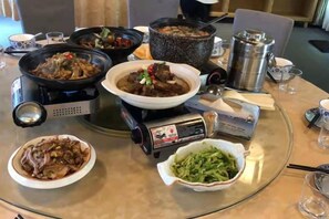 A table with various dishes, a portable stove, and a teapot. - Taohuayuan Liu Contract Chun Inn (Taoyuan)