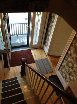 Stairs lead to an outdoor area, connecting indoor and outdoor spaces with a traditional design.