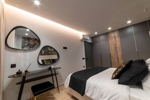 A modern bedroom with a bed, bedside tables, a desk, and a large mirror. - Inviting 4-bed Villa Lia in Vathianos Kampos (Hersonissos)