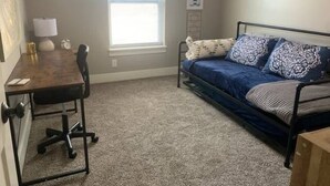 A bedroom with a bed, a desk, and a chair. - Bettendorf Condo: 2BR, 2BA, Garage, King master, Pets Welcome! (Bettendorf)