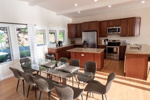 Open concept kitchen and dining area connects with the living room.