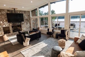 The living room boasts large windows and a gas fireplace.