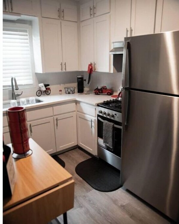 Enjoy cooking in this well-equipped kitchen with a refrigerator, gas stove, and oven.