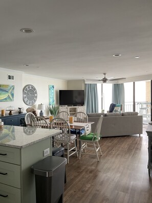 Relax in a cozy living space with a dining area, flat-screen TV, and comfortable seating.
