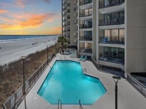 Relax by the rooftop pool surrounded by a low concrete deck and take in the views of the city from the adjacent high-rise building.