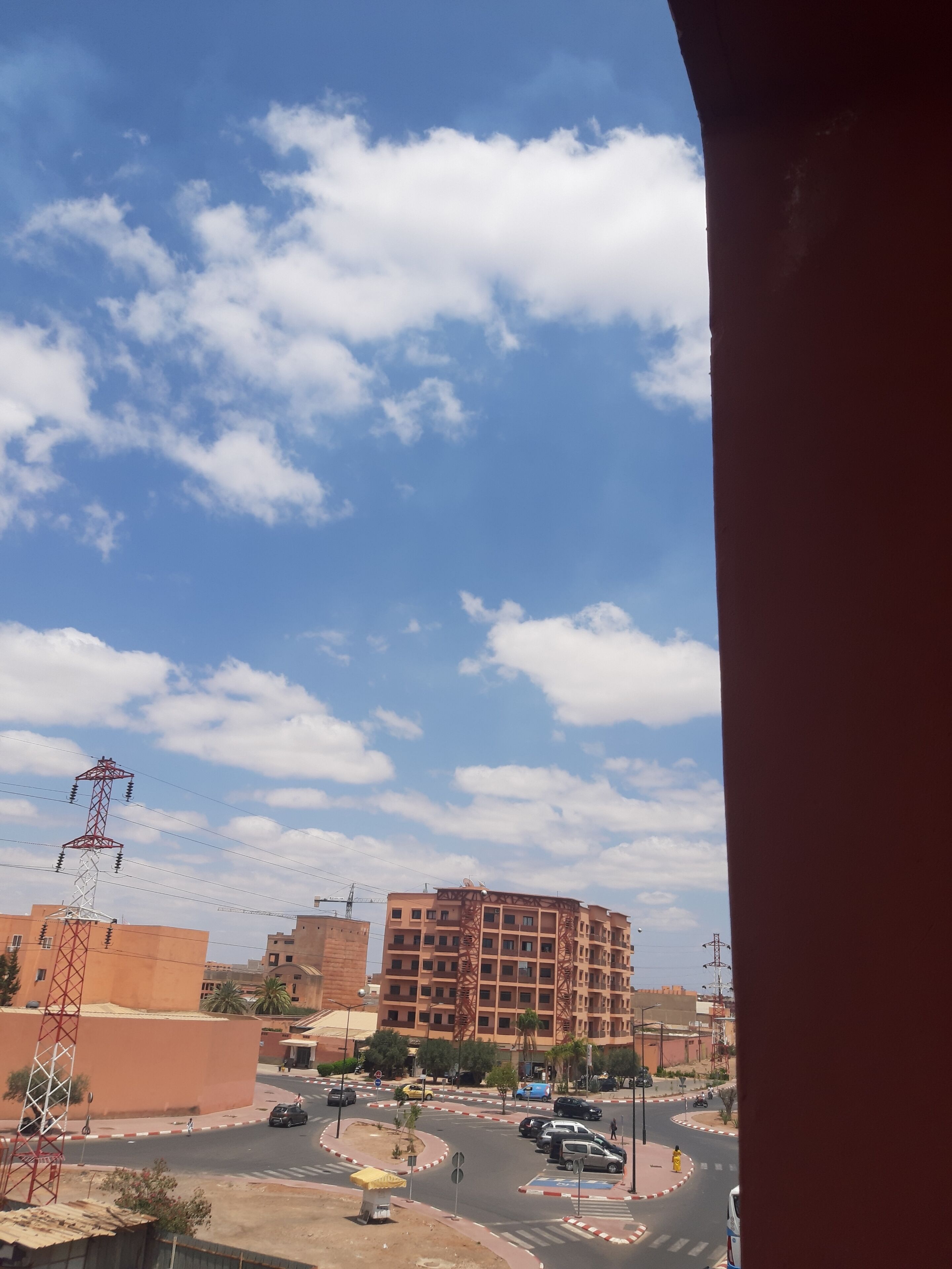 A view of a roundabout with buildings and a clear sky.