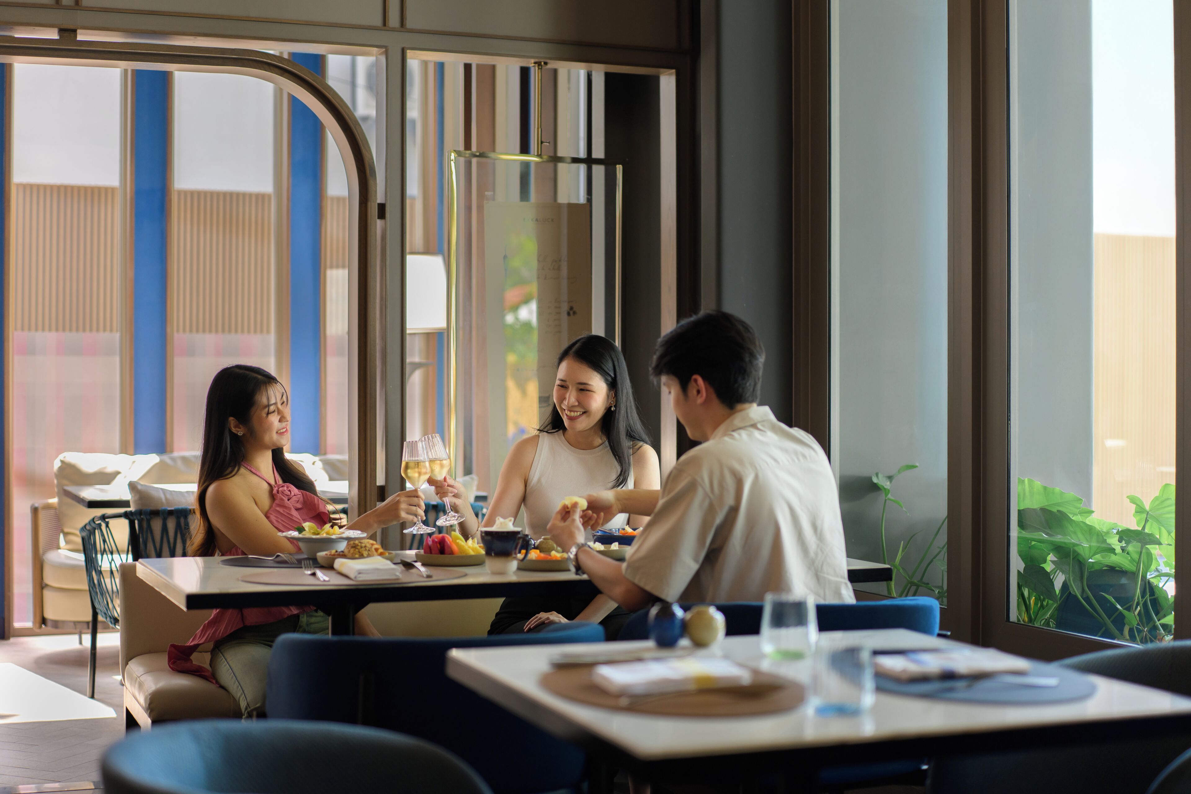 A dining area with tables, chairs, and a view of the outdoors.