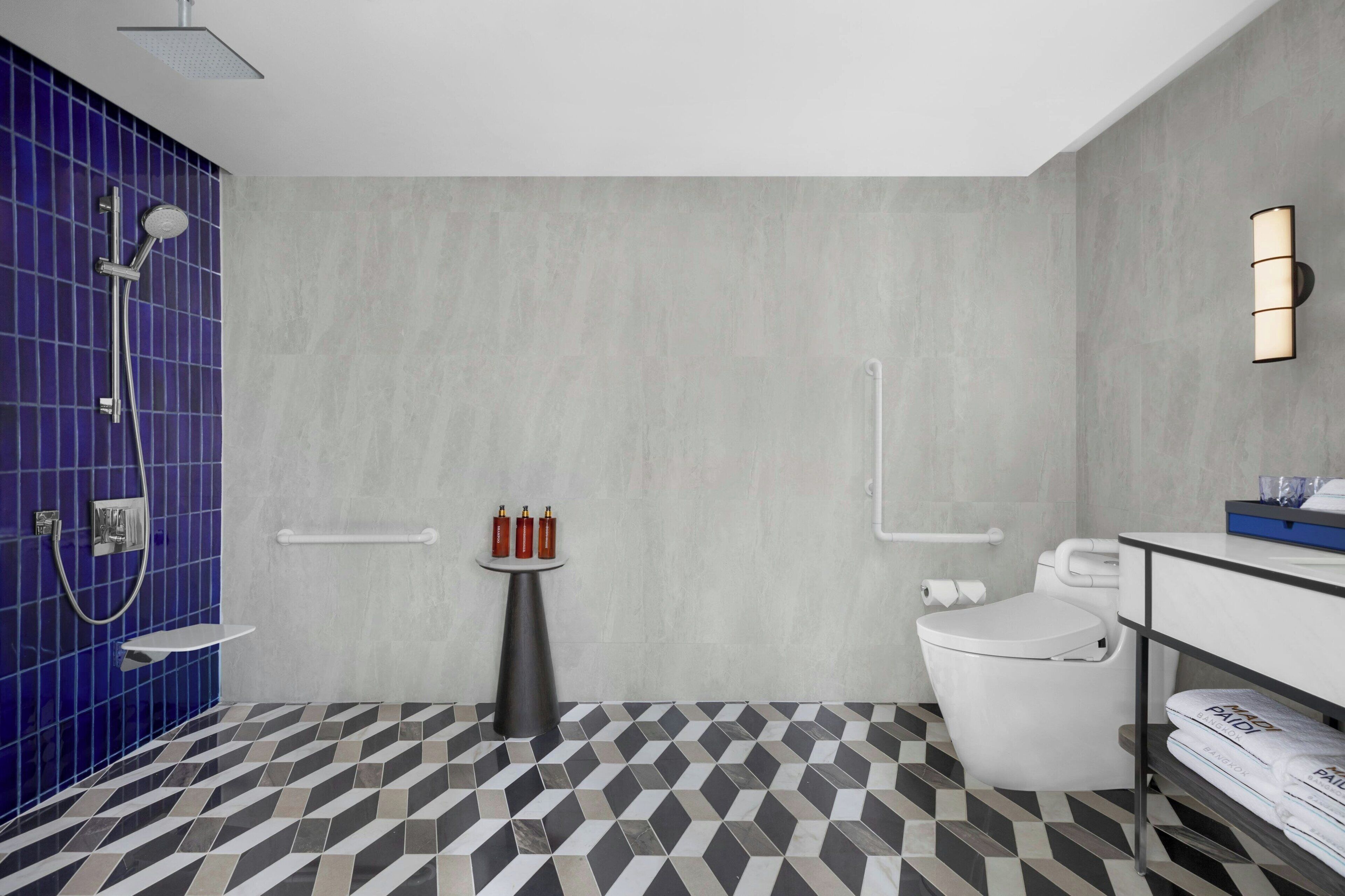 A modern bathroom with a shower, toilet, and sink.