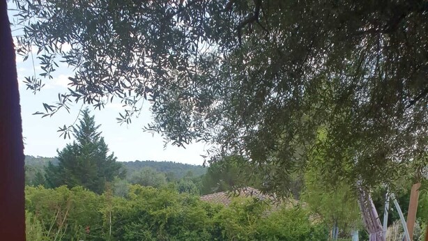 A swimming pool surrounded by greenery, with a patio area and a view of hills in the background. - Maison "La Miloune" au Coeur de la Provence Verte, Dans Quartier Calme et Arboré (Le Val)