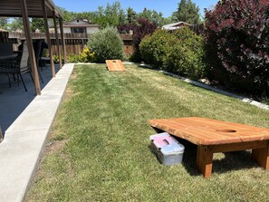 Enjoy outdoor dining or relaxation in this, landscaped yard with a flat lawn and two picnic tables.