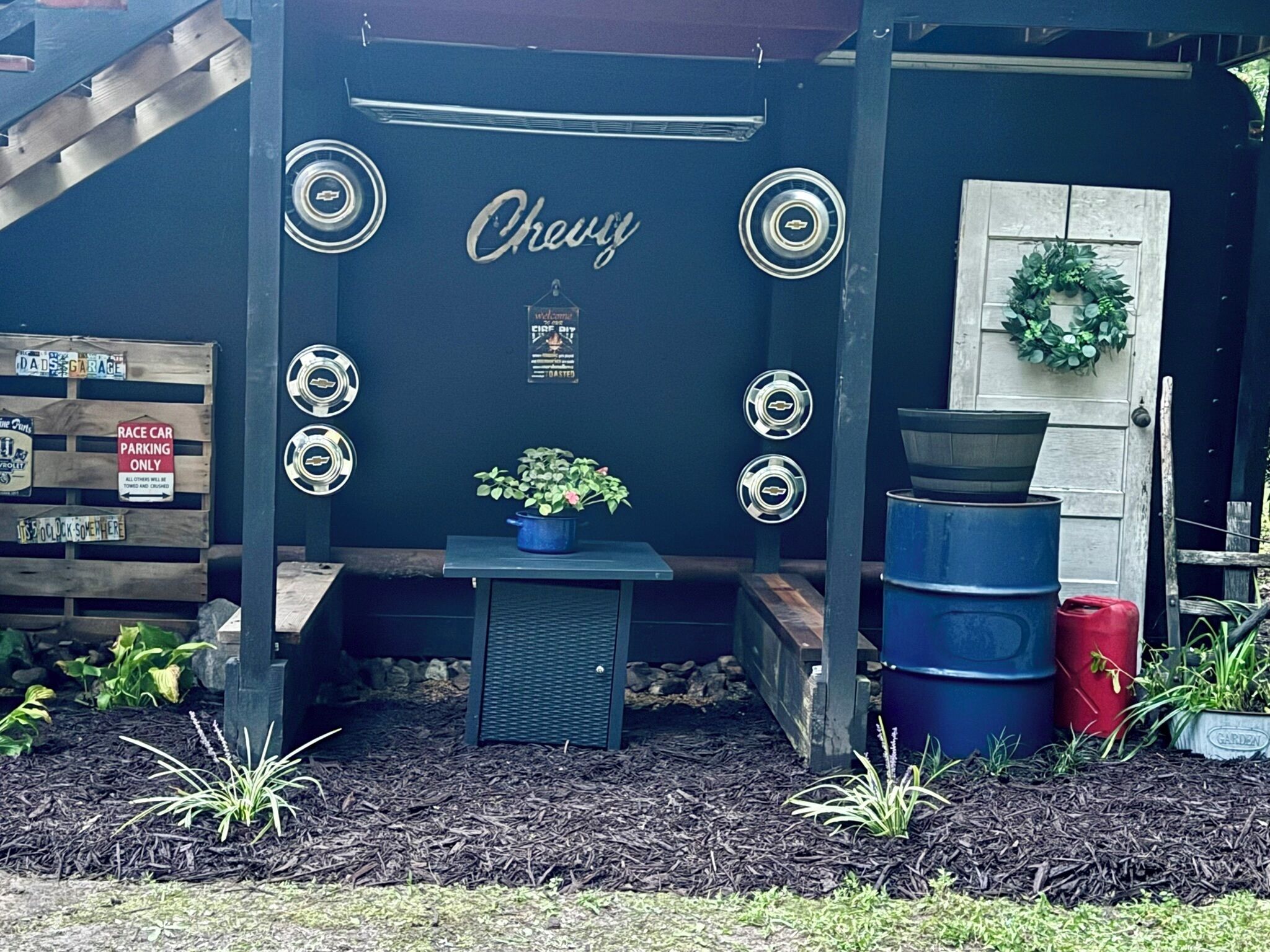 A garage with a Chevrolet logo, a welcome sign, and a wreath on the door.