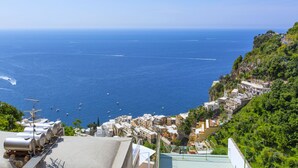 A coastal town with buildings on a hillside overlooking the sea.