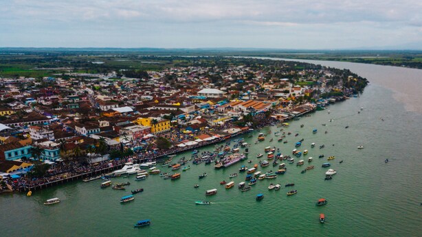 An aerial view of a coastal town with dense buildings along the waterfront and numerous boats in the water. - Hotel Posada Doña Lala (Tlacotalpan)