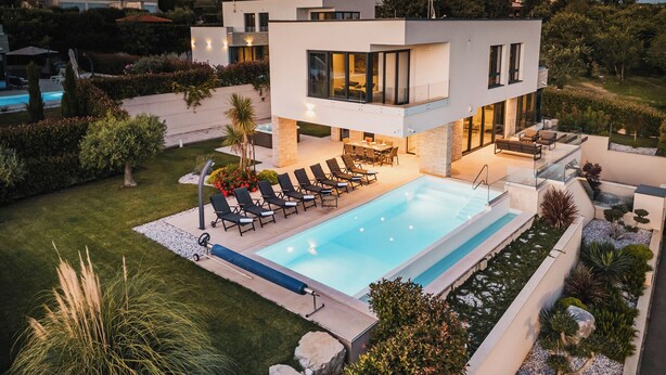 A modern two-story house with a swimming pool, outdoor seating, and well-maintained landscaping. - 4BD villa for up to 8 with large swimming pool, jacuzzi, sauna, gym, bocci (Brnobići)