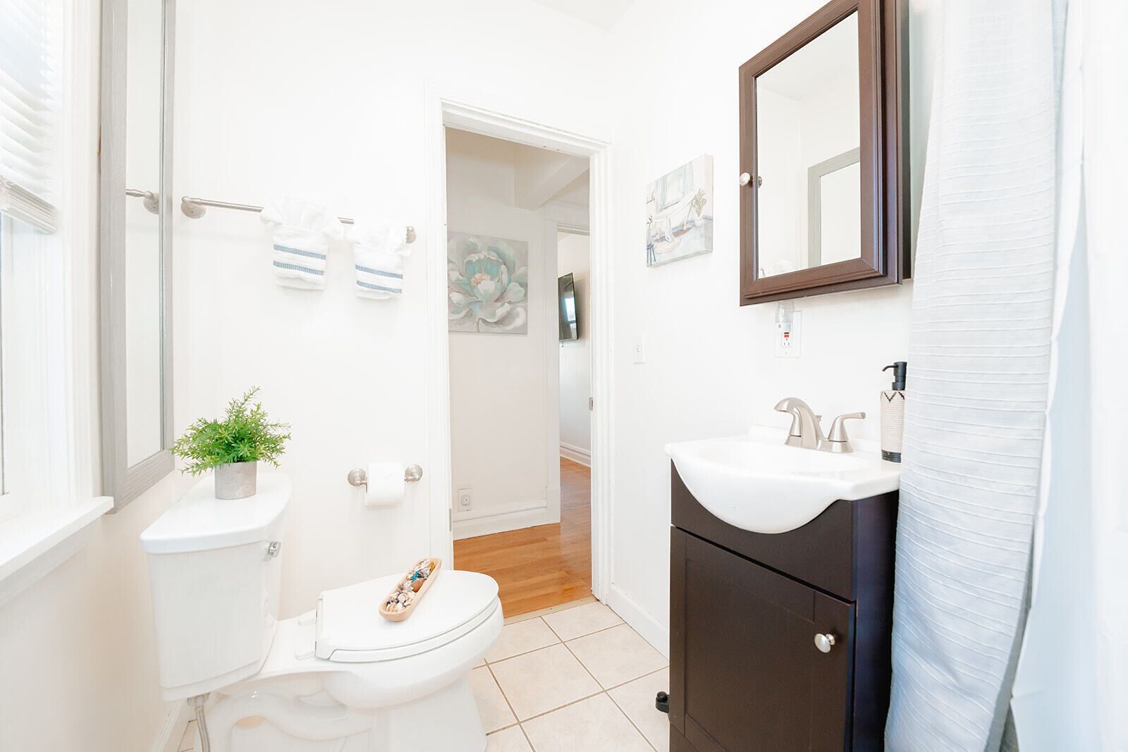 A modern bathroom with a toilet, sink, and shower.