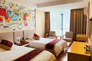 A hotel room with two beds, a desk, a chair, and a large wall mural. - Xingyu Theme Hotel (Huangshan Scenic Area) (Huangshan City)
