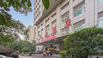 A multi-story building with a prominent entrance and signage.