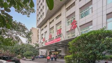 A multi-story hotel with a prominent entrance and signage.