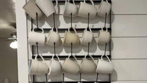 A wall-mounted rack holding multiple white mugs. - The White House Hub (Inkom)