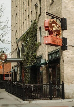 A building with a neon sign reading "Theater" and a brick facade. - The Cowboy Inn - Luxury Bozeman (Bozeman)