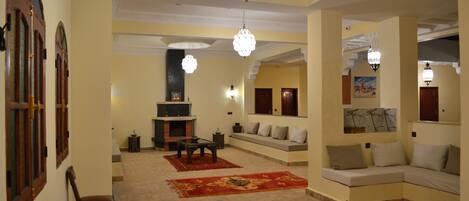A living room with a fireplace, sofas, and a coffee table.