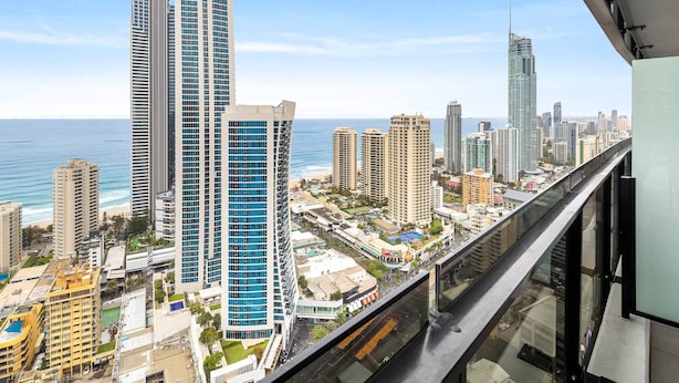 Un hotel moderno con vistas al océano y al horizonte de la ciudad.