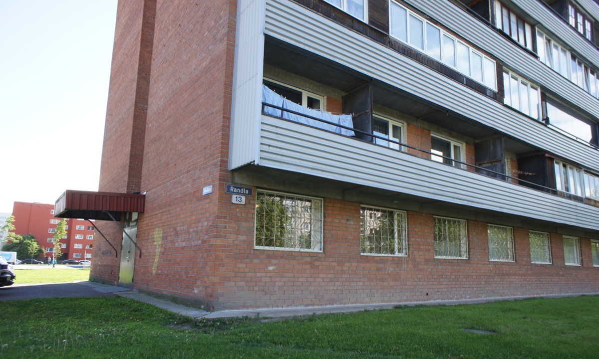 A multi-story building with a brick facade and a flat roof.