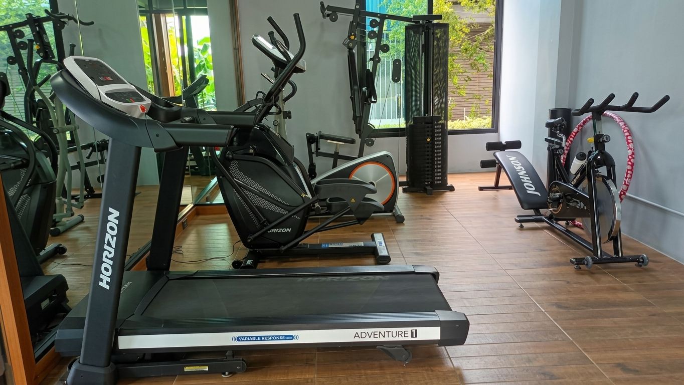 A gym with treadmills, a stationary bike, and a rowing machine.