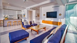 A modern living space with a kitchen, dining area, and seating area.