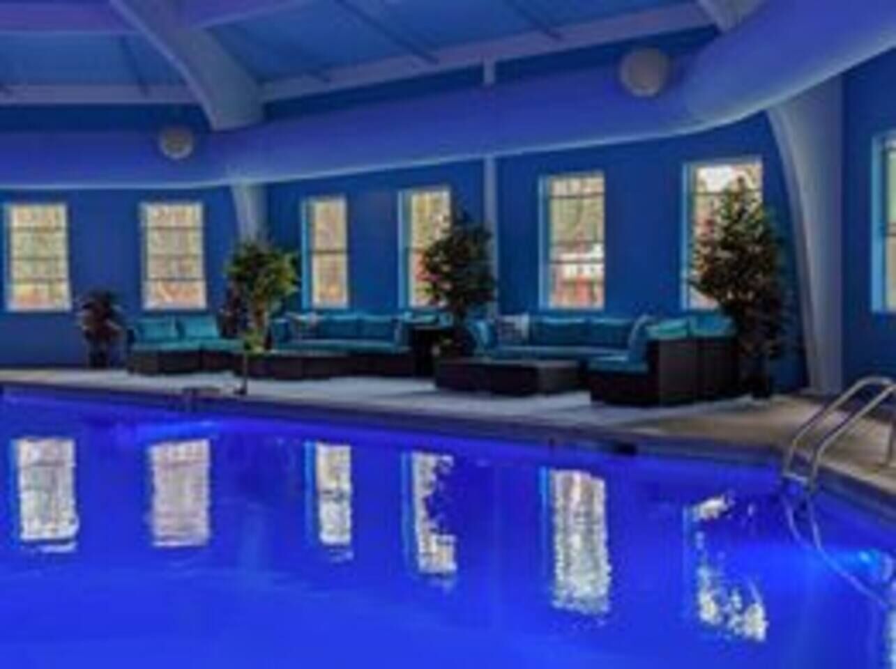 Ein Hallenbad mit blauen Wänden und Fenstern.