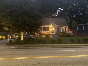 Stroll up to the entrance of this charming home, where a welcoming porch and beautifully manicured yard await.