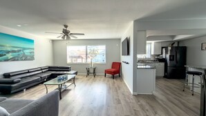 A modern apartment with a living room, kitchen, and dining area. - Lovely Apartment Close to the Beach ! (Cape Canaveral)