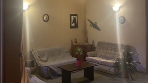 A cozy living room with two sofas, a coffee table, and a fireplace.