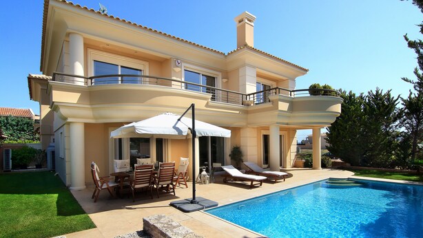 A two-story house with a swimming pool, outdoor furniture, and a well-maintained lawn. - Contemporary luxury villa with eclectic design a few steps away from Varkiza bay (Vari)