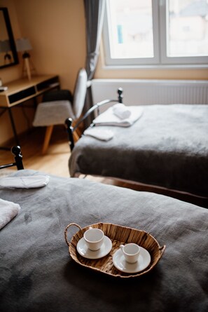 A hotel room with a bed, a bedside table, and a window. - Savčić Apartmani (Petrovac)