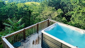 A hot tub on a wooden deck with a view of a forested valley. - Little Greenbriar Lodge: Free Attraction Tickets, Hot Tub, Mtn Views & Adjacent National Park (Sevierville)