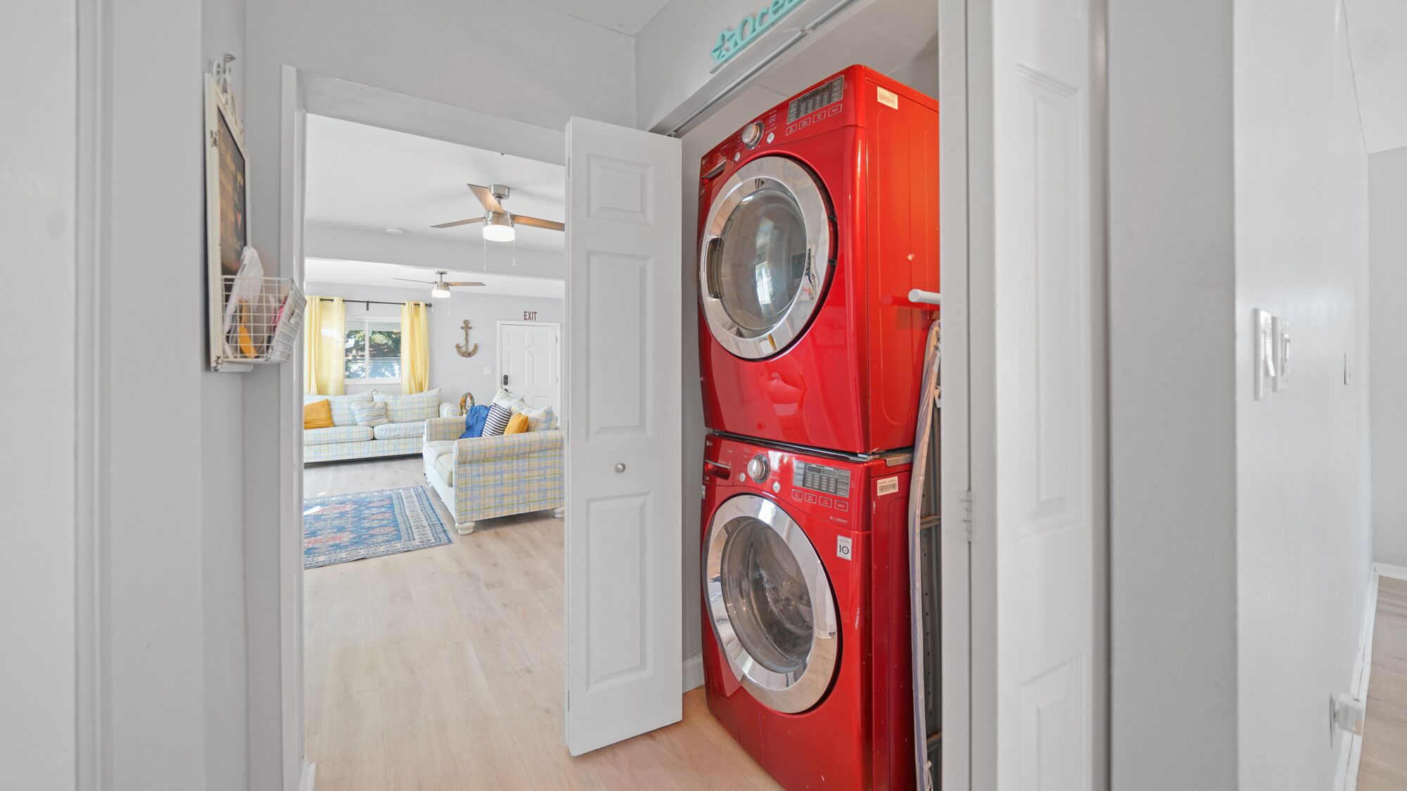 A laundry room with two stacked front-loading washing machines.